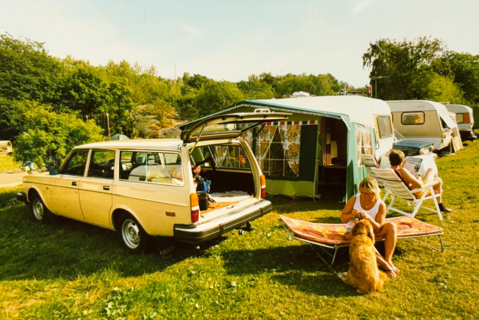 1980s camping - Volvo 245, caravans and tents. The perfect summer setup.